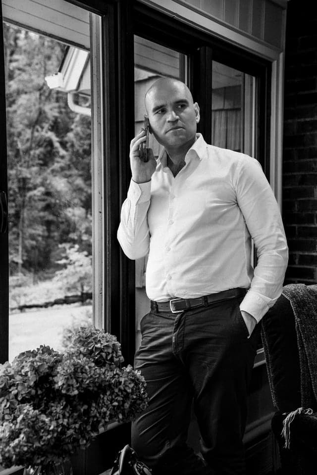 Michael Fabiano on a phone call, photographed in black and white