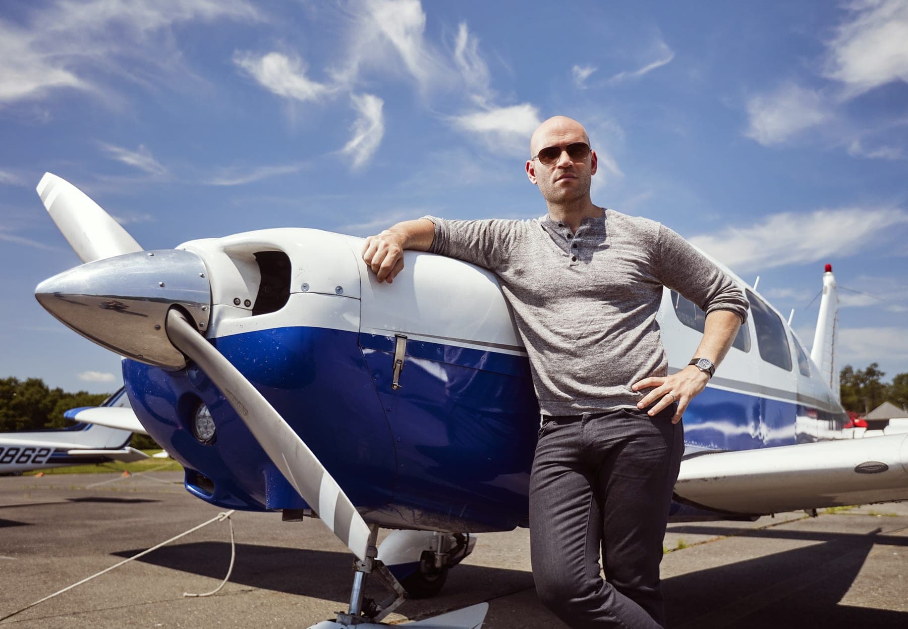 Michael Fabiano beside a light aircraft on an airfield apron