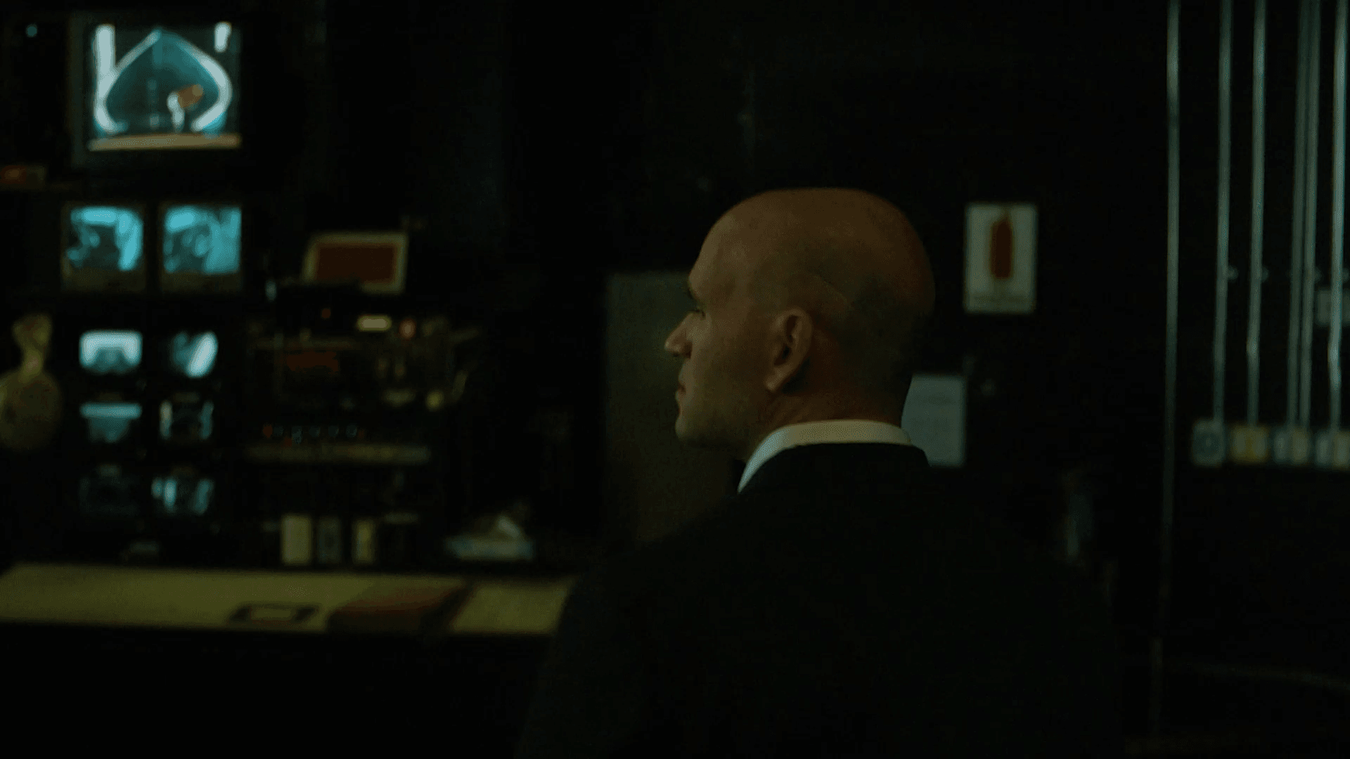 Michael Fabiano in profile backstage, waiting in the wings beside a stage monitor desk